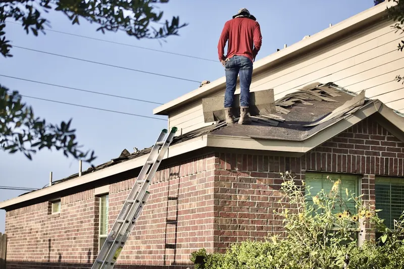 Professional roofer working on a residential roof in Quail Lake